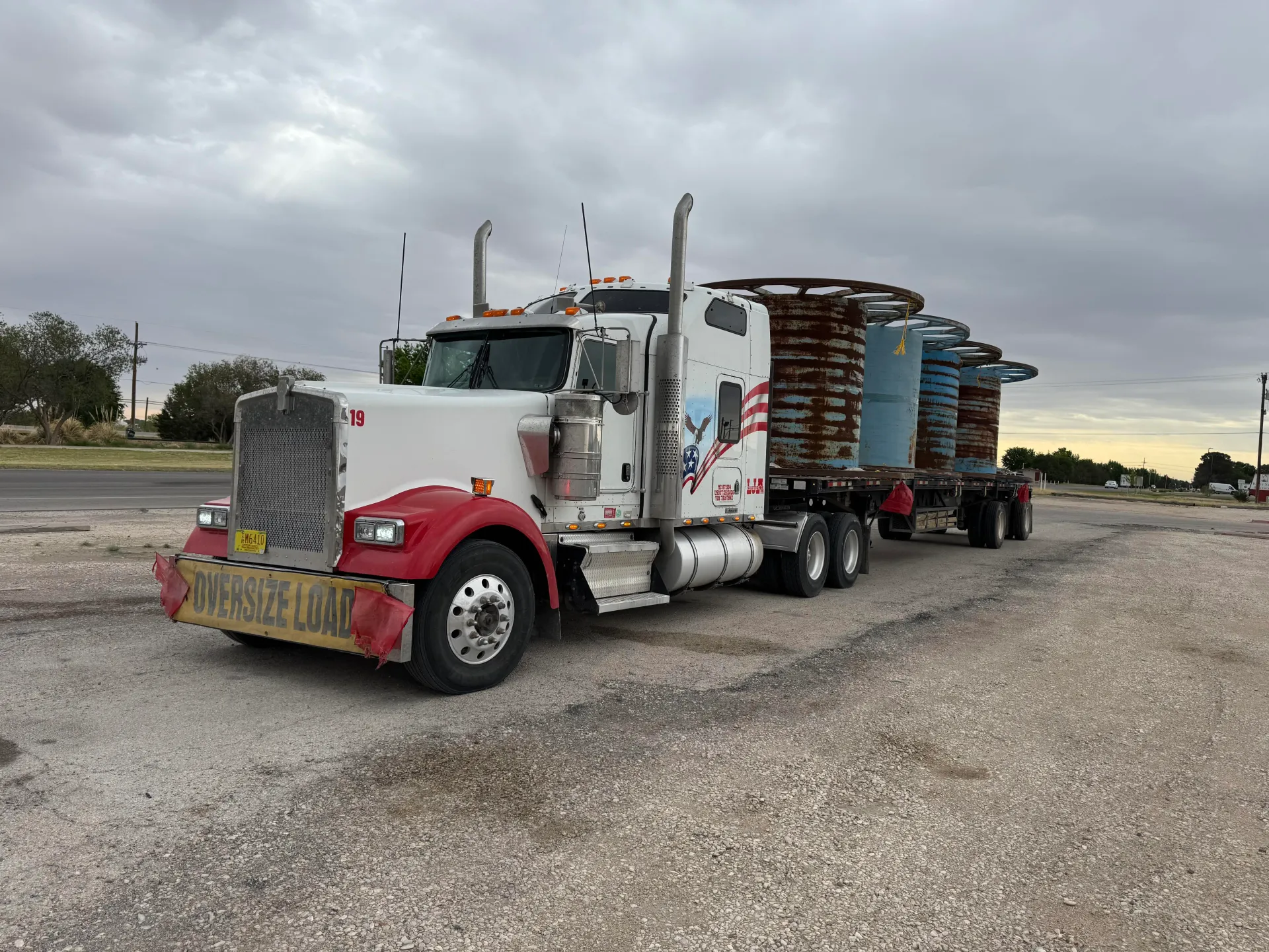 LJA Solutions LLC red-and-white heavy-haul truck carrying oversized equipment